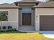 Modern home exterior with double door entry and garage at 13707 Begonia Cir, Port Charlotte, FL 33981