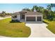 Two-car garage and a landscaped front yard at 13707 Begonia Cir, Port Charlotte, FL 33981