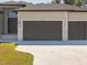 Two-car garage with dark brown doors at 13707 Begonia Cir, Port Charlotte, FL 33981