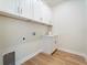 Laundry room with white cabinets and a quartz countertop at 13707 Begonia Cir, Port Charlotte, FL 33981