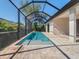 Inviting pool area with screened enclosure and paver deck at 13707 Begonia Cir, Port Charlotte, FL 33981