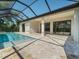 Inviting pool area with covered patio, pavers, and screened enclosure at 13707 Begonia Cir, Port Charlotte, FL 33981