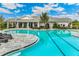Community resort-style pool with plenty of lounge chairs and seating at 1437 Powell Valley Dr, Port Charlotte, FL 33953