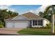 Two-story home with a three-car garage and attractive landscaping at 1496 Mableton Dr, Port Charlotte, FL 33953