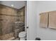 Clean bathroom with a tile shower and stone accent wall at 1501 San Cristobal Ave # 1205, Punta Gorda, FL 33983