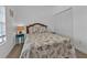 Bedroom with double bed, seashell bedding, and teal nightstand at 1501 San Cristobal Ave # 1205, Punta Gorda, FL 33983