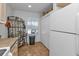 Kitchen area with white appliances and pantry at 1501 San Cristobal Ave # 1205, Punta Gorda, FL 33983