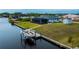 Backyard view showing pool, canal, and boat dock at 15308 Acorn Cir, Port Charlotte, FL 33981