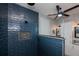 Modern bathroom with blue tile shower, built-in seat and glass enclosure at 15308 Acorn Cir, Port Charlotte, FL 33981