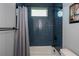 Modern bathroom with blue tile, shower/tub combo at 15308 Acorn Cir, Port Charlotte, FL 33981