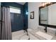 Modern bathroom with blue tile, granite vanity, and bathtub at 15308 Acorn Cir, Port Charlotte, FL 33981