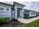 Modern house exterior with gray walls and landscaping at 15308 Acorn Cir, Port Charlotte, FL 33981