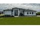 Gray house with a modern design, landscaping, and walkway at 15308 Acorn Cir, Port Charlotte, FL 33981