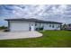 House exterior showcasing a white garage door and concrete driveway at 15308 Acorn Cir, Port Charlotte, FL 33981