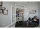 Spacious home office with glass french doors and view into the living room at 15308 Acorn Cir, Port Charlotte, FL 33981