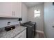 Bright laundry room with granite countertop and storage at 15308 Acorn Cir, Port Charlotte, FL 33981
