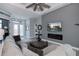 Living room features a sectional sofa and electric fireplace at 15308 Acorn Cir, Port Charlotte, FL 33981
