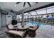 Relaxing pool area with covered patio and seating at 15308 Acorn Cir, Port Charlotte, FL 33981