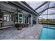 Spacious pool area with covered patio, seating, and grill at 15308 Acorn Cir, Port Charlotte, FL 33981