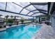 Relaxing pool area with covered lanai, loungers, and canal view at 15308 Acorn Cir, Port Charlotte, FL 33981