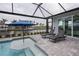 Relaxing poolside patio with lounge chairs and umbrella at 15308 Acorn Cir, Port Charlotte, FL 33981
