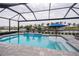 Inviting swimming pool with screened enclosure and canal view at 15308 Acorn Cir, Port Charlotte, FL 33981