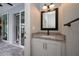 Convenient powder room with granite vanity and mirror at 15308 Acorn Cir, Port Charlotte, FL 33981
