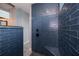 Walk-in shower with blue tile and built-in seat at 15308 Acorn Cir, Port Charlotte, FL 33981