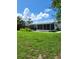 Large backyard with screened enclosure and lush grass at 158 Concord Ne Dr, Port Charlotte, FL 33952