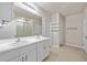 Bathroom with double vanity, white cabinets, and a shower at 16039 Quinta Dr, Punta Gorda, FL 33955