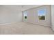 Bedroom with carpeted floor, ceiling fan, and large windows at 16039 Quinta Dr, Punta Gorda, FL 33955