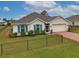 One-story home with light beige walls, blue shutters, and a brick paver driveway at 16039 Quinta Dr, Punta Gorda, FL 33955