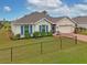 House exterior with blue shutters and brick driveway at 16039 Quinta Dr, Punta Gorda, FL 33955