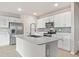 Modern kitchen with white cabinets, quartz countertops, and stainless steel appliances at 16039 Quinta Dr, Punta Gorda, FL 33955