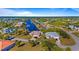 Aerial view of waterfront home with canal access and lush landscaping at 17220 Horizon Ln, Port Charlotte, FL 33948