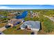 Aerial view of canal-front home with lush landscaping at 17220 Horizon Ln, Port Charlotte, FL 33948