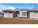 One-story home with light-colored exterior and manicured lawn at 17220 Horizon Ln, Port Charlotte, FL 33948