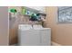 Bright laundry room with washer, dryer, and ample storage at 17220 Horizon Ln, Port Charlotte, FL 33948