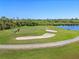 Aerial view of golf course with sand traps and a water feature at 1906 Creek Nine Dr, North Port, FL 34291