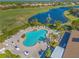 Resort-style pool with lounge chairs and a fountain, overlooking the golf course at 1906 Creek Nine Dr, North Port, FL 34291