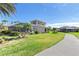 Home's backyard features a screened patio and lush lawn at 1906 Creek Nine Dr, North Port, FL 34291