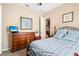 Bedroom with dresser and view into kitchen at 1906 Creek Nine Dr, North Port, FL 34291