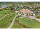 Aerial view of clubhouse with golf course and tennis courts at 1906 Creek Nine Dr, North Port, FL 34291