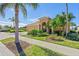 House exterior showcasing landscaping and a paved driveway at 1906 Creek Nine Dr, North Port, FL 34291