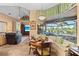 Kitchen nook with window seat, offering a picturesque view of the pool and golf course at 1906 Creek Nine Dr, North Port, FL 34291