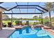 Enjoy this gorgeous pool and spa with screened enclosure and tranquil lake view at 1906 Creek Nine Dr, North Port, FL 34291