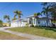 House exterior showcasing a three-car garage and palm trees at 193 Beeney Se Rd, Port Charlotte, FL 33952