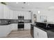 Modern kitchen with stainless steel appliances and granite countertops at 193 Beeney Se Rd, Port Charlotte, FL 33952