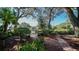 Landscaped patio with stone pathway and benches overlooking a pond at 19505 Quesada Ave # Rr203, Port Charlotte, FL 33948