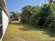 Side yard with grassy area and landscaping at 2057 Wonderwin St, Port Charlotte, FL 33948